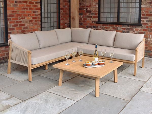 Angled Roma garden furniture 5 seater corner lounge set with beige cushions around a wooden small table