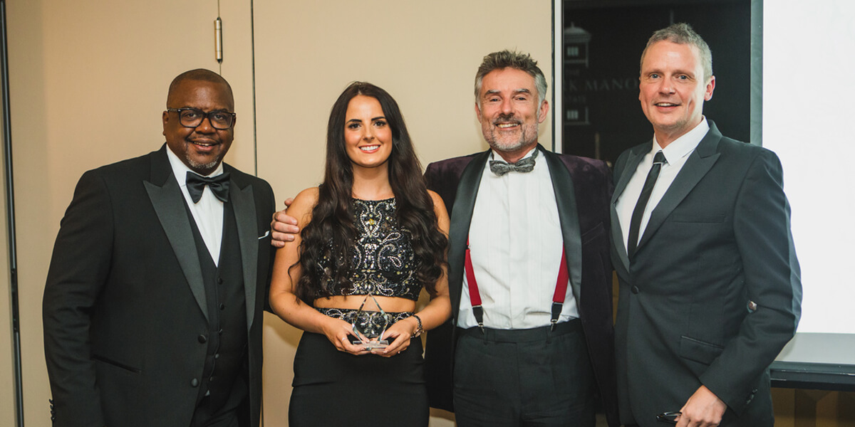 Michael Giscombe and Greg Kane present a Customer Service Award to Polly and Richard Manser