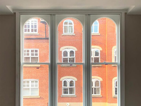 Incarnation Secondary Glazing fitted to white sash arch top window